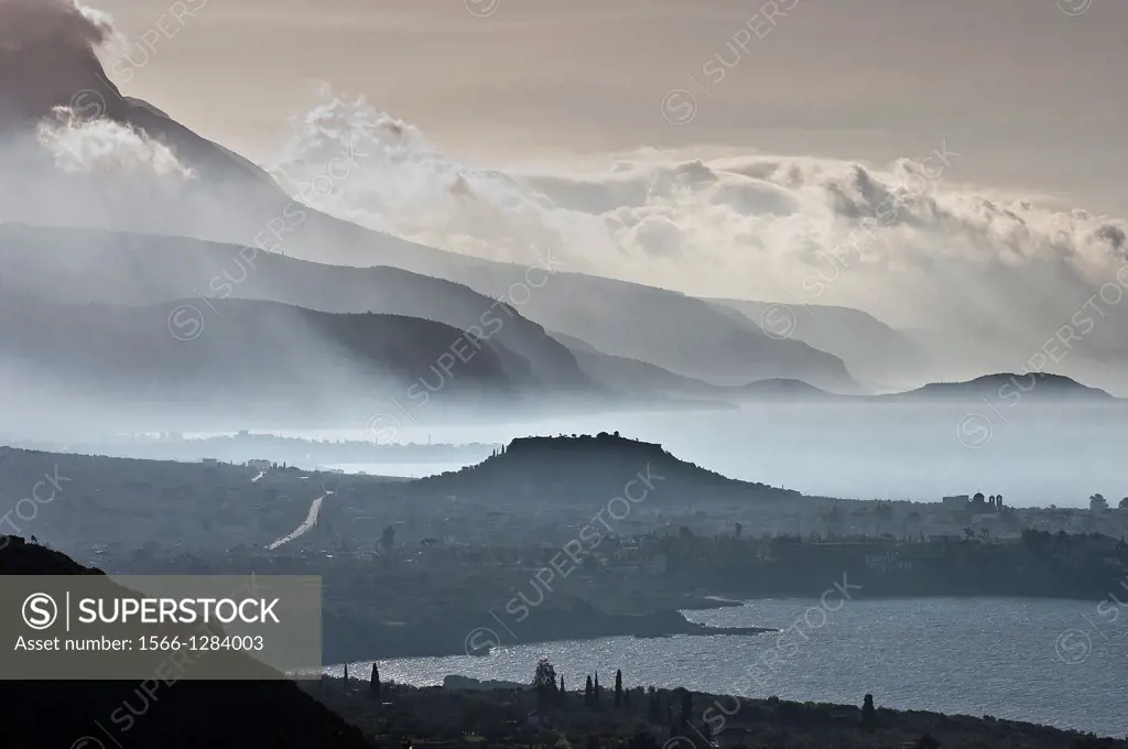Looking south down the Messinian coast of the outer Mani on a misty morning with. The seaside town of Stoupa and the prominent mound of its ancient ac...