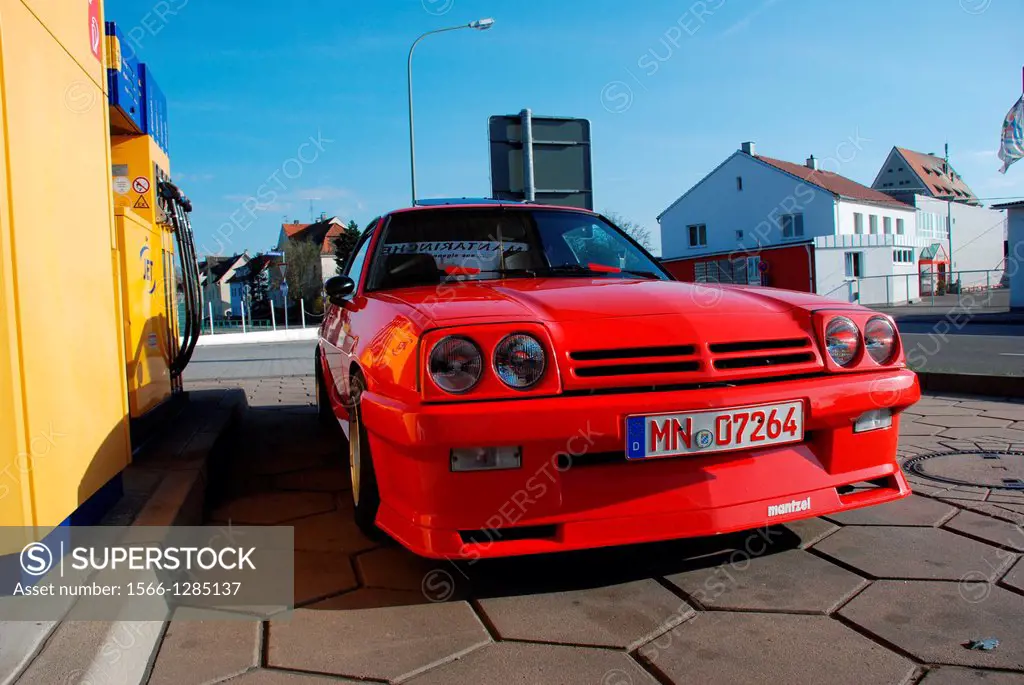 Red Opel Manta at a gas station
