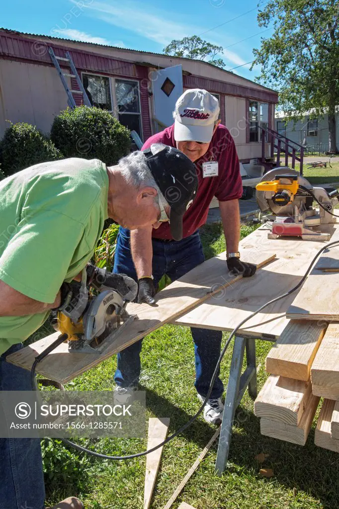 Franklin, Louisiana - Volunteers replace the rotted floor of an elderly resident's mobile home that was damaged by storms. Ed Lobnitz (left) and Phili...