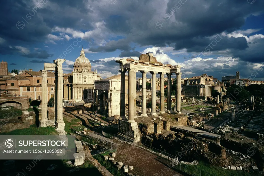Rome. Italy. The Roman Forum (Foro Romano). Foreground L-R, the Temple of Vespasian, the Church of Santi Luca e Martina, Arch of Septimius Severus and...