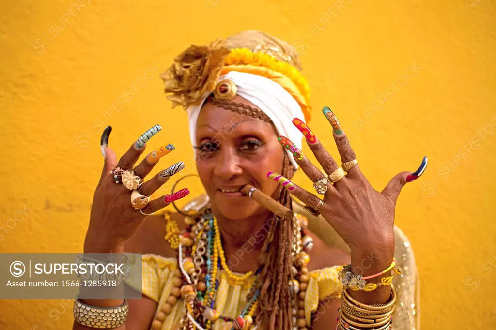 Senora Habana, A priestess of the afro-cuban Santeria with colourful long nails and cigar, Havana, Cuba, Caribbean.