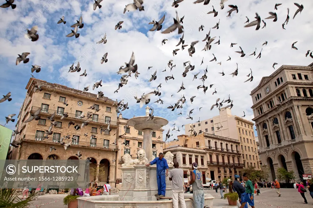 pigeons over the marble fountain Fuente de los Leones on Plaza de San Francisco in Havana, Cuba, Caribbean.