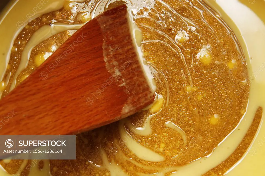 Muscovado sugar, butter and honey melting in a pan.