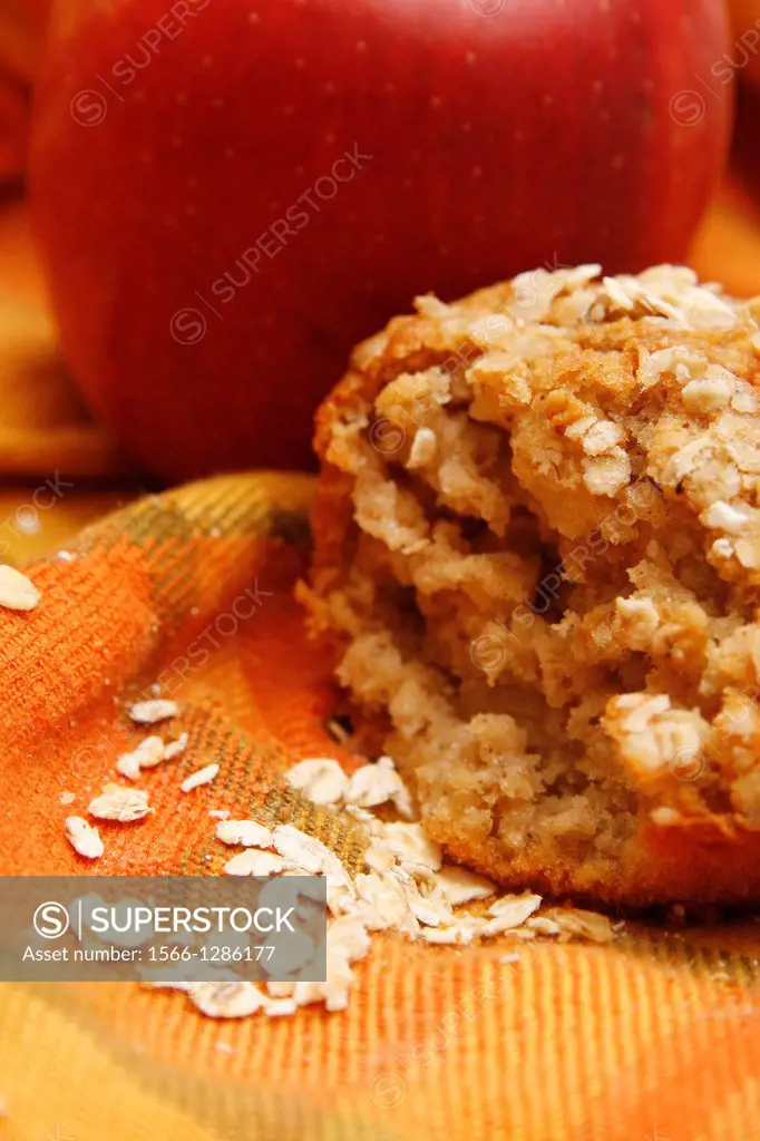 apple and oat muffin on orange towel.