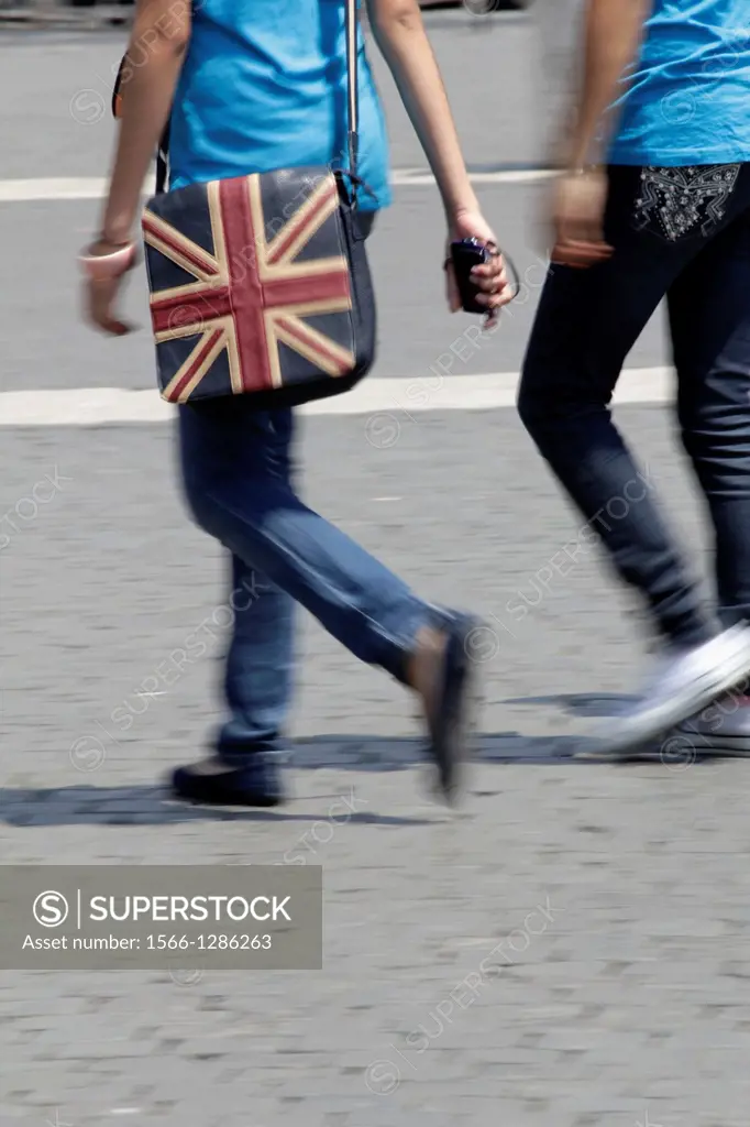 person with union jack bag in street road in city town.