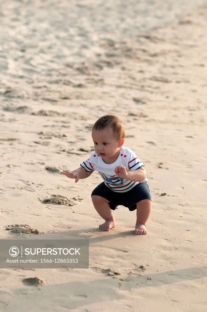 Baby on the beach, First steps on the sand.