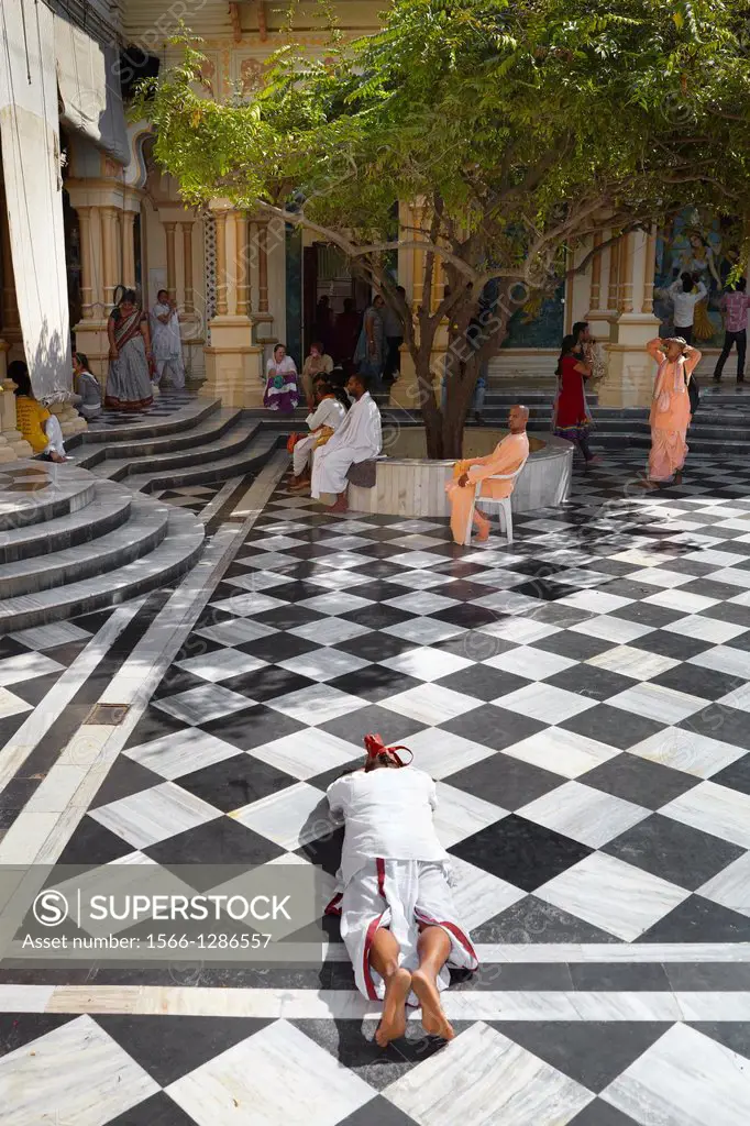 Hare KrishnaTemple in Vrindavan - devotee prostrating on the temple floor, Vrindavan, Uttar Pradesh, India, Asia.