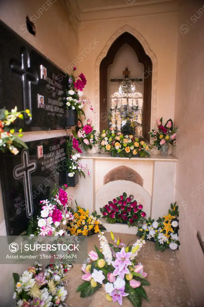 Relatives and friends of the dead cleaned and decorated with flowers given May 1st to remember the dead, Alzira, Comunidad Valenciana, Valencia, Spain...