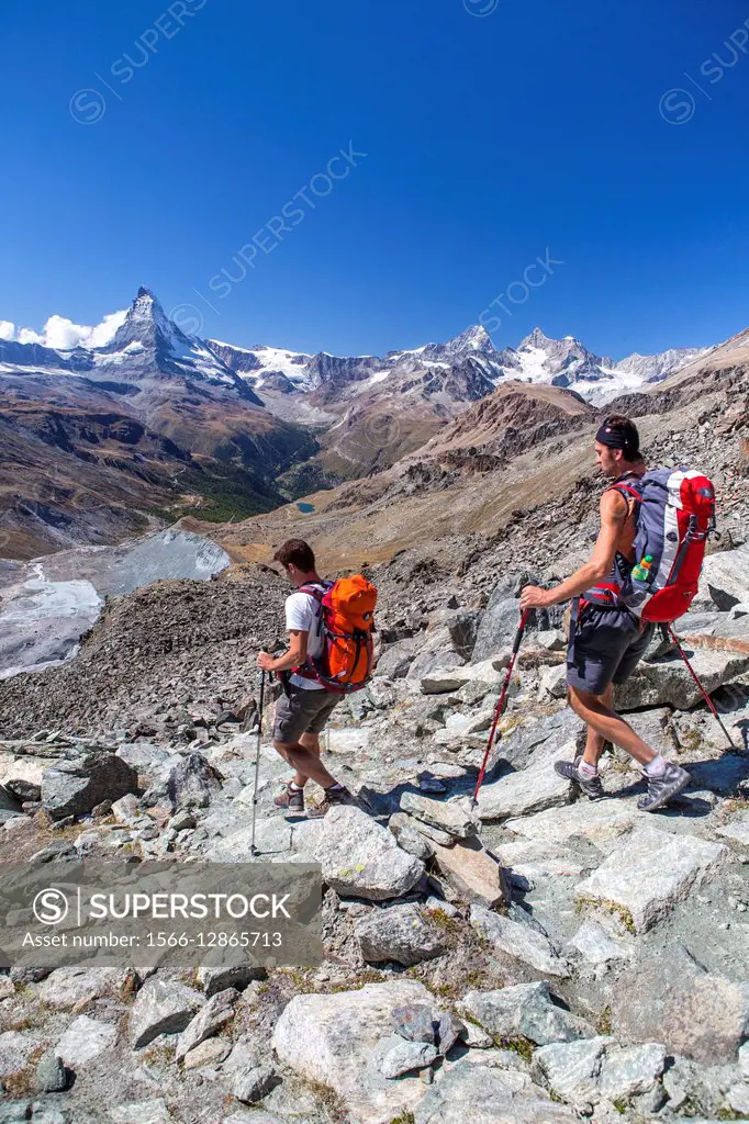 Hikers proceed towards the Matterhorn. Zermatt Canton of Valais Pennine Alps Switzerland.