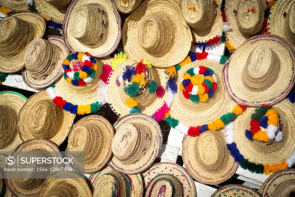 Different straw hats typical of Morocco in a stall of the road. Morocco, Africa
