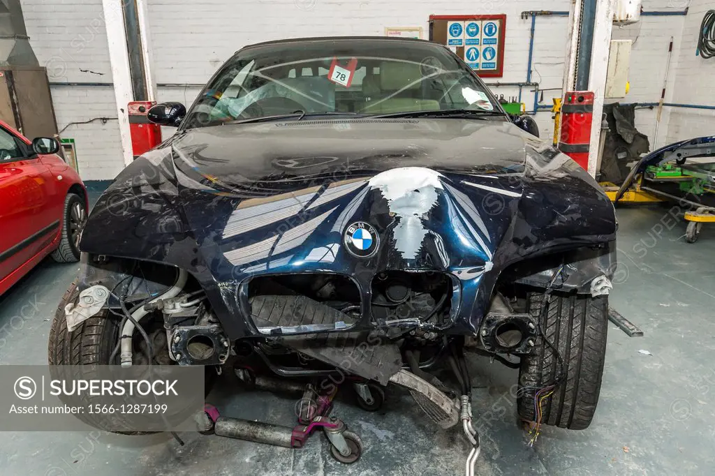 crashed car in garage workshop,poulton,lancashire,england,uk,europe.
