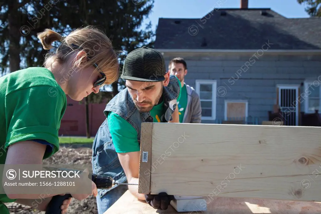 Detroit, Michigan - Volunteers from Comcast and Starbucks build raised boxes for a community garden. The garden is being developed by Motor City Bligh...