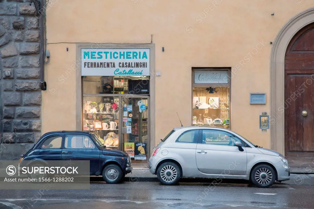 New and Old Fiat 500 Car outside Traditional Shop in Florence, Italy.