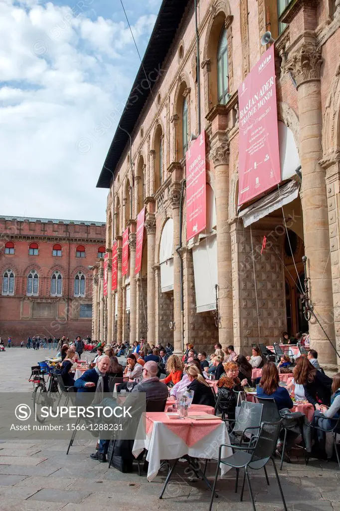 People Sitting at Cafe Tables outside the Palazzo del Podesta Palace in the Piazza Maggiore - Main Square in Bologna; Italy.
