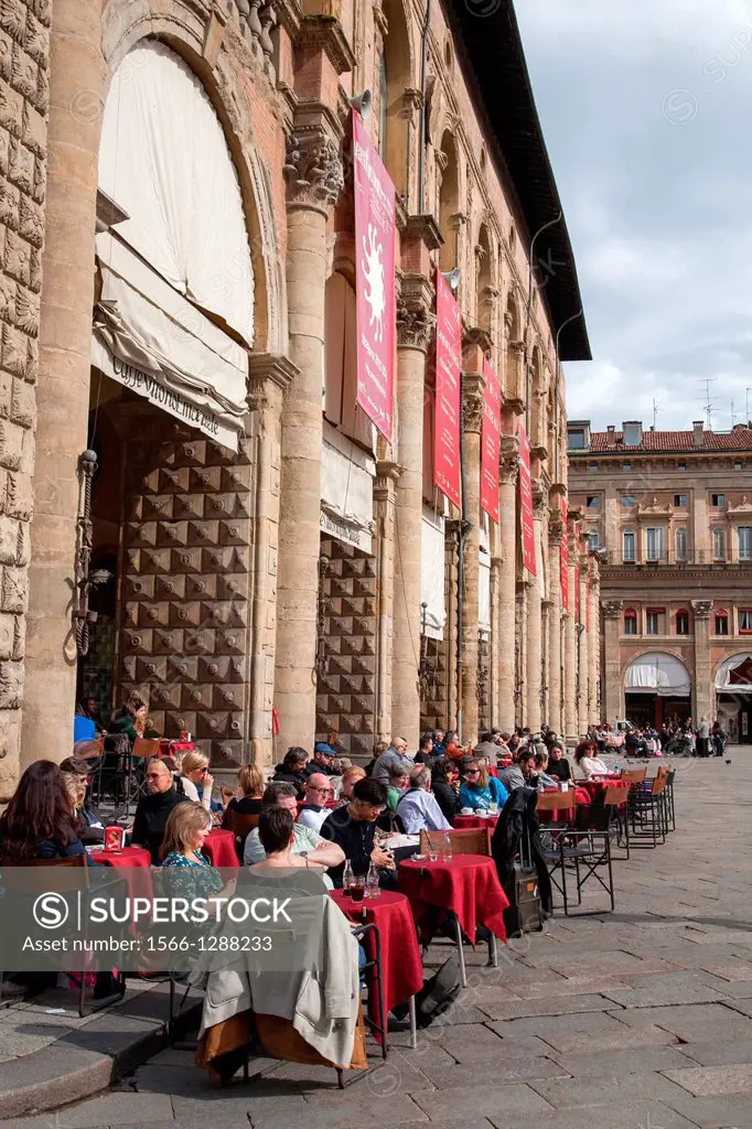 People Sitting at Cafe Tables outside the Palazzo del Podesta Palace in the Piazza Maggiore - Main Square in Bologna; Italy.