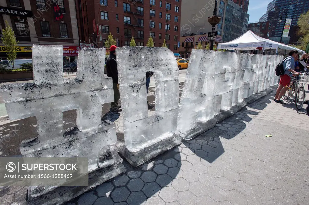 An ice sculpture by the Dark Snow Project covered in soot is seen at an Earth Day fair in Union Square Park in New York. The Dark Snow Project contend...