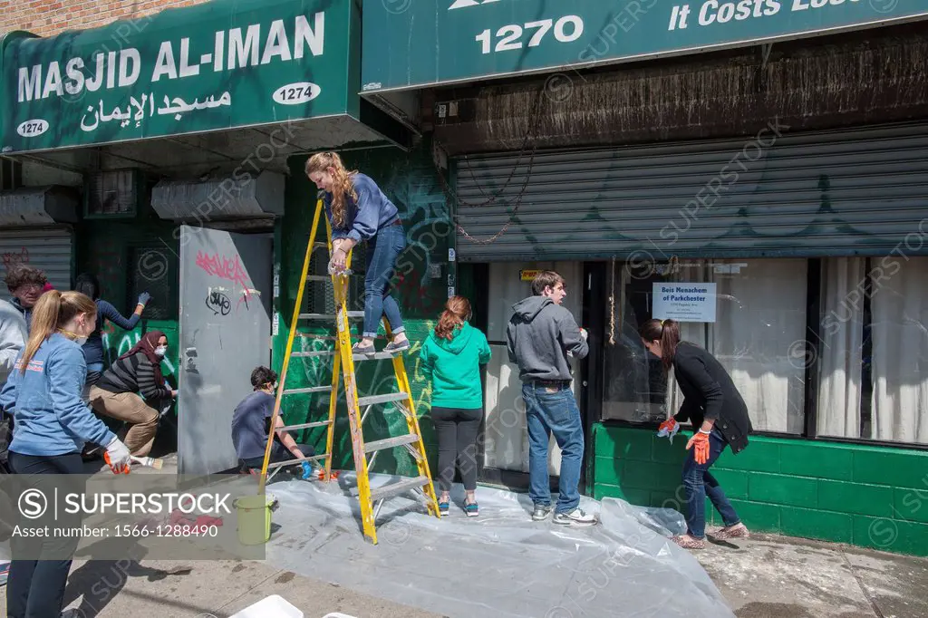 Volunteer teens from the predominantly Catholic Manhattan College, the Islamic Leadership School and Cong. Tehillah of Riverdale paint and clean the s...