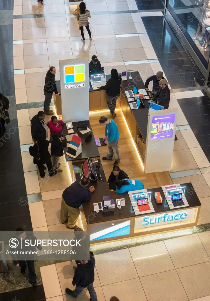 Shoppers at the Microsoft kiosk, selling Windows 8 and the Surface tablet, in the Time Warner Center in New York. Microsoft has recently released an a...