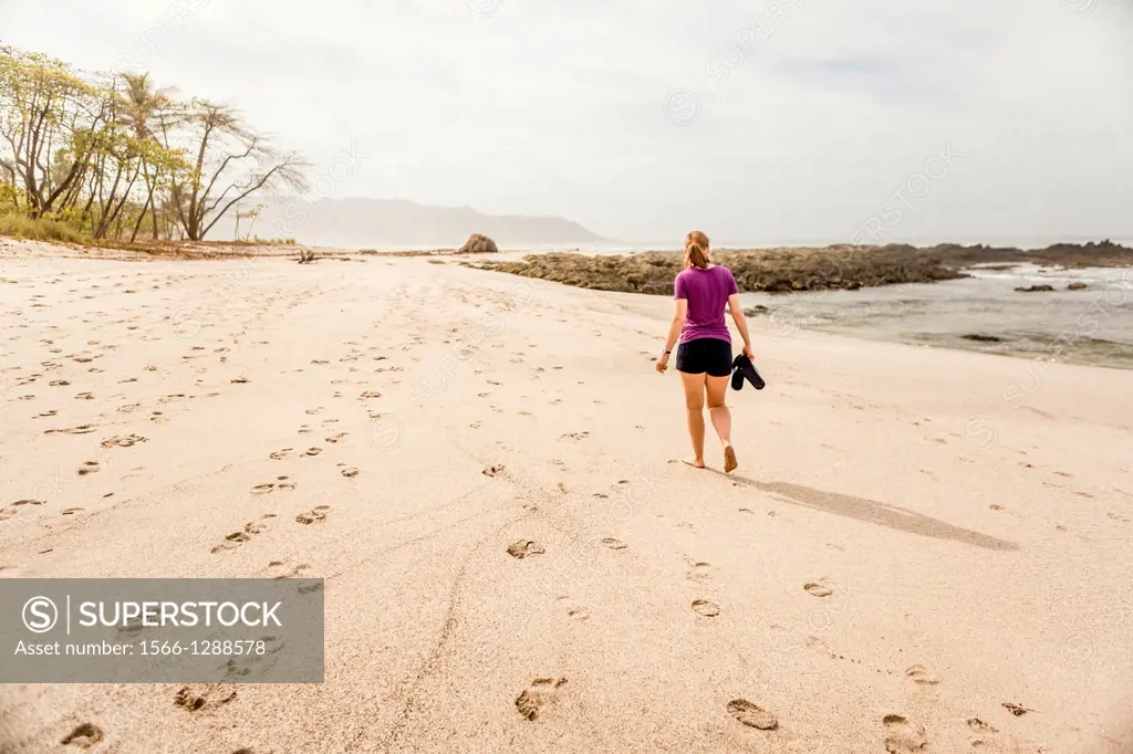 Woman walking on Playa Carmen, Costa Rica.