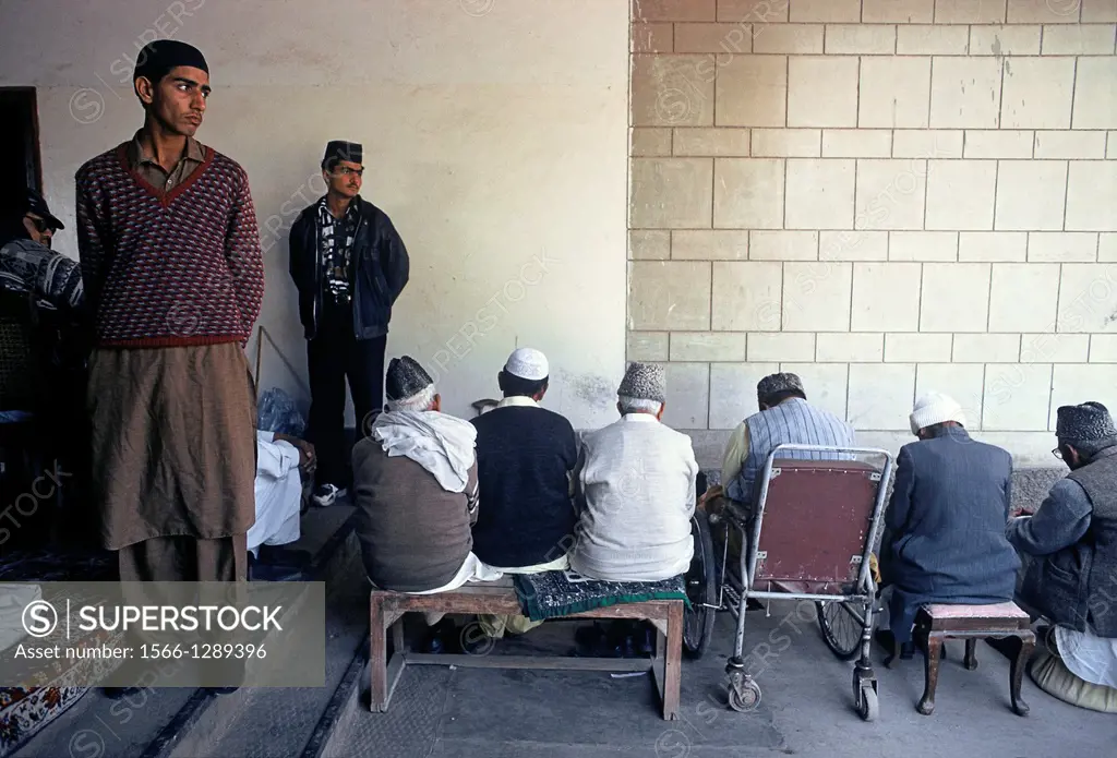 Two men are monitoring the Friday prayer in a mosque of the Ahmadi sect. Rabwah, Pakistan. Rabwah is the town where is located the headquarters of the...