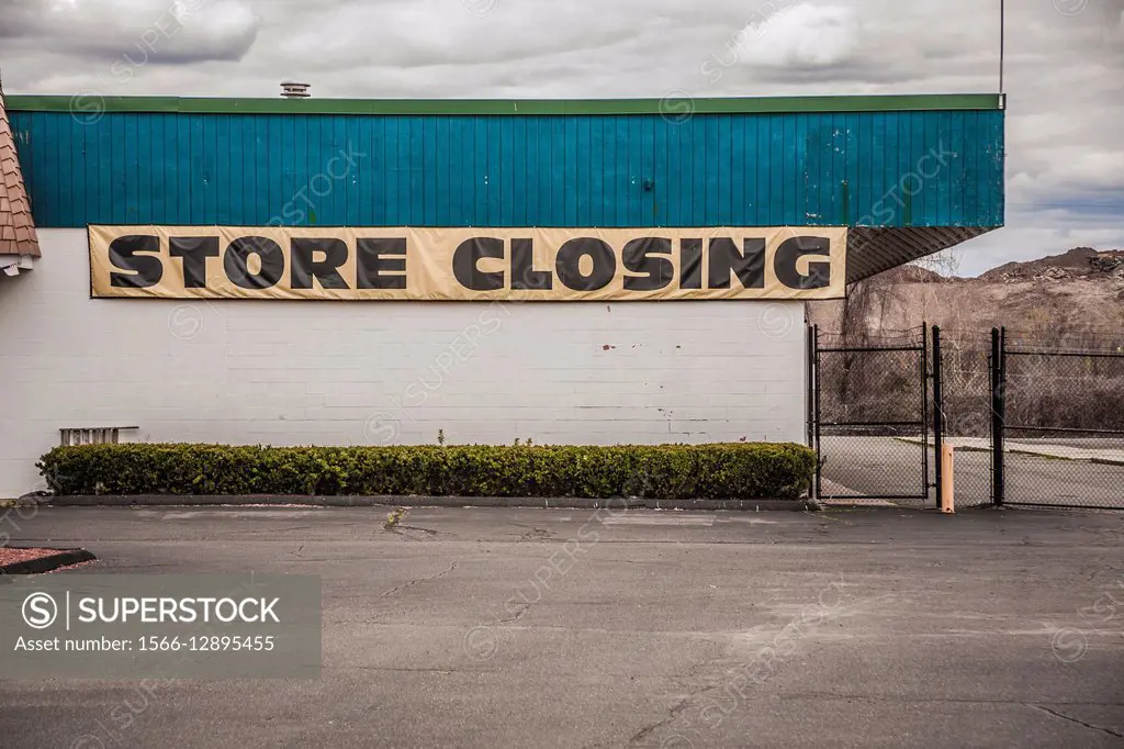 Sign on a store reading ""Store Closing"".