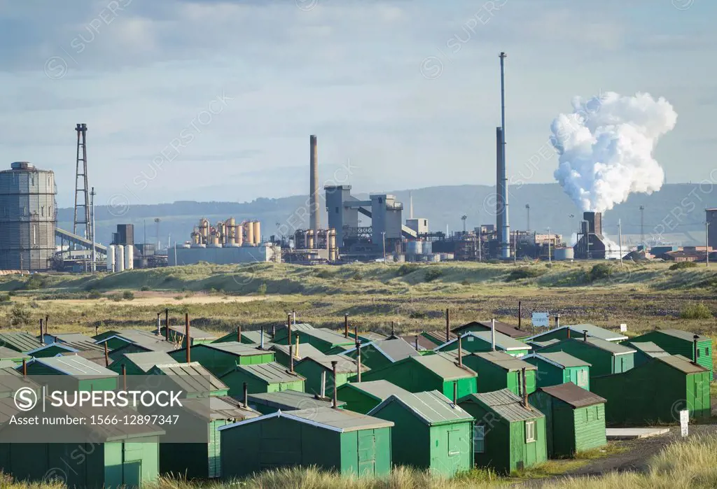 View over Fishermen`s huts towards Redcar Steelworks. South Gare, Redcar, north east England. United Kingdom.