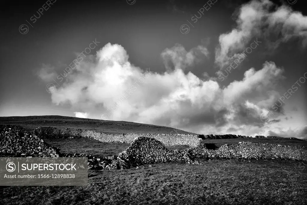 Landscape with Dry stone wall, and clouds in the sky. Kettlewell, Yorkshire Dales, North Yorkshire, England, UK, Europe.