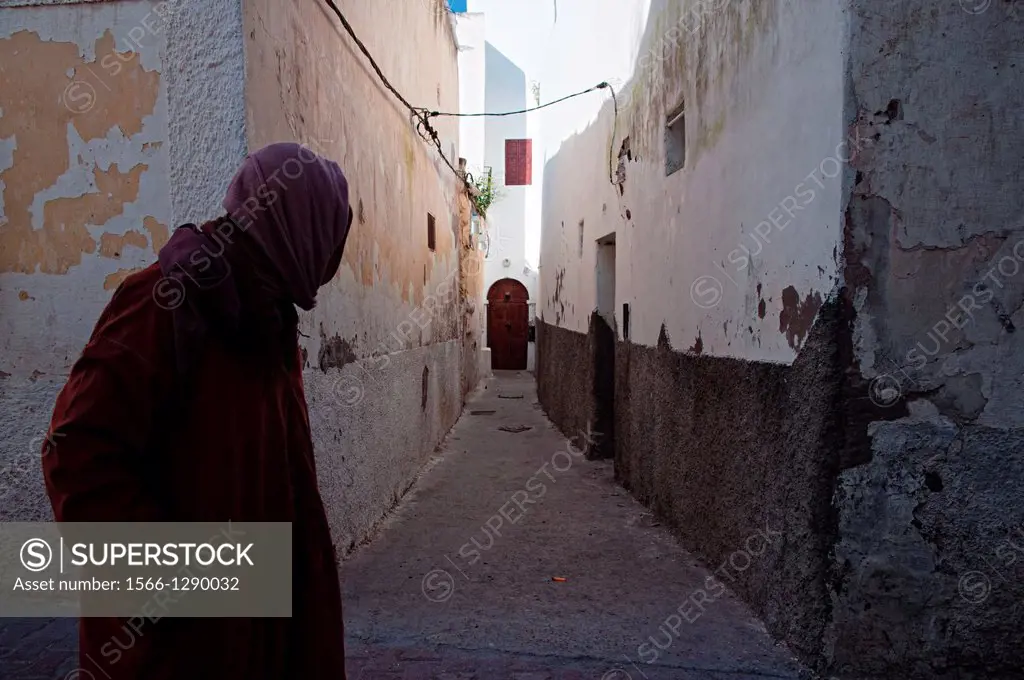 Man walking through an alleyway in Azemmour medina, Morocco.