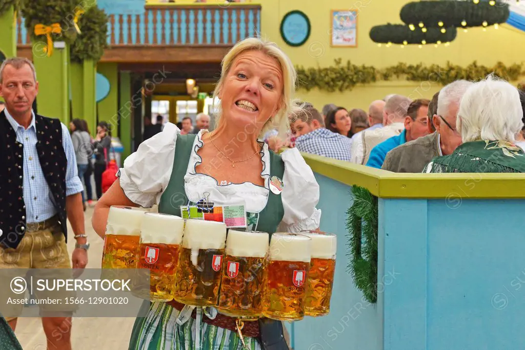 Waitress carrying masses of beer at Oktoberfest in Munich, Germany.