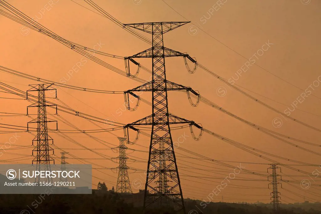 High voltage towers along the Taiwan highway at dusk.