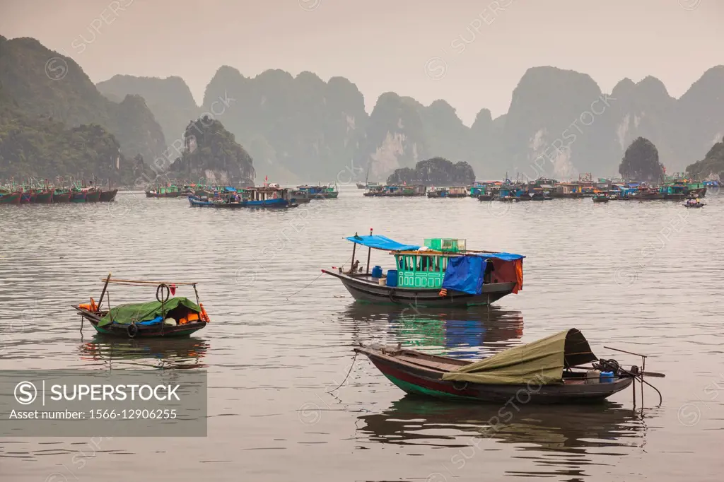 Vietnam, Halong City, Halong Bay fishing boats, dusk.