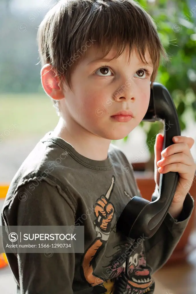 Boy using a retro telephone.