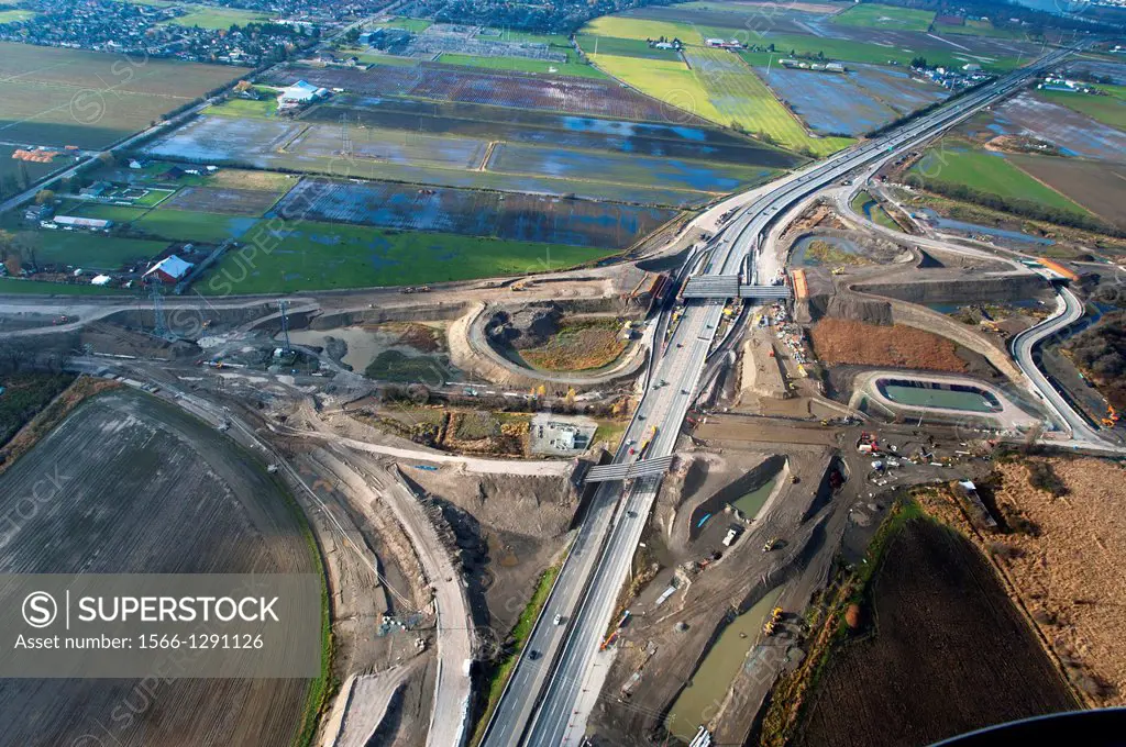 Canada, BC, Delta. Aerial view of South Fraser Perimiter Road construction, crossing Hwy 99.