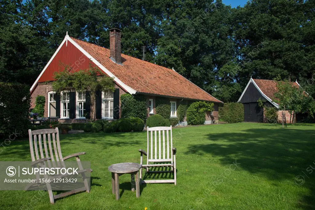 Old traditional farm with sunchairs in the Achterhoek in Holland
