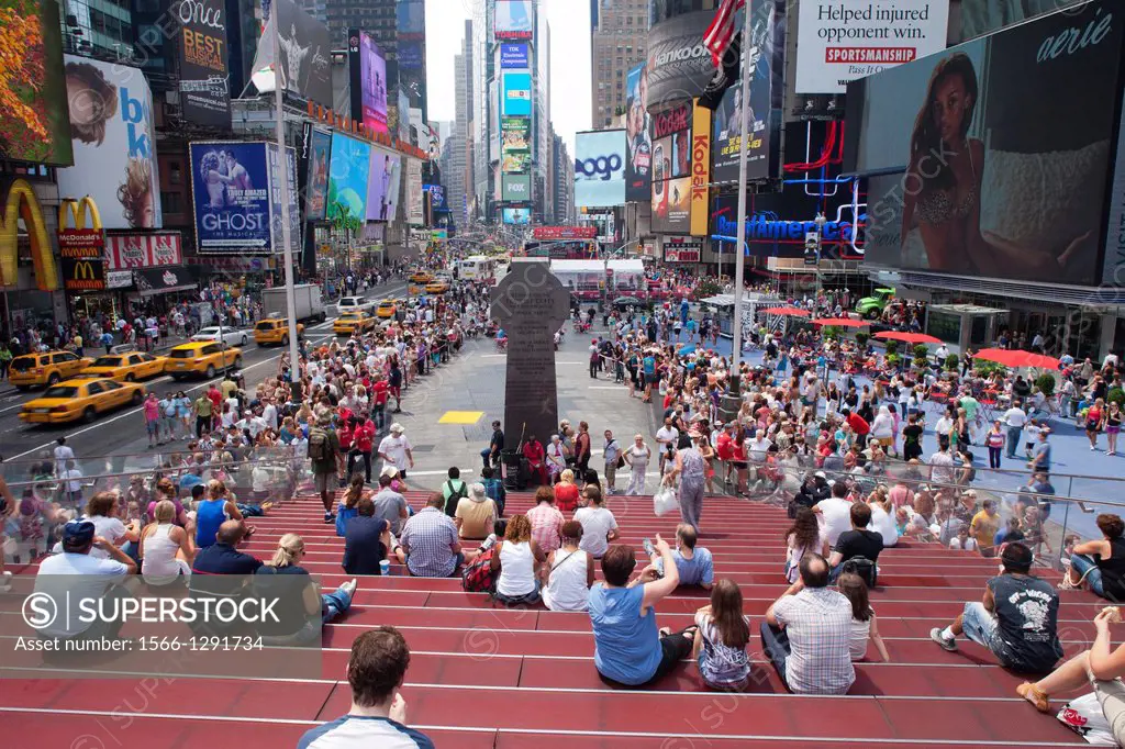 Crowd Sitting On Red Steps Tkts Center Times Square Midtown Manhattan New York City Usa.