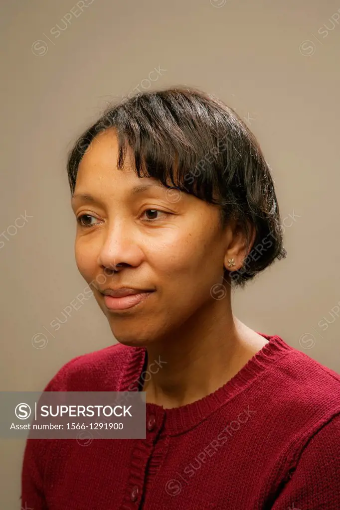 Portrait of African American woman with short black hair wearing a maroon sweater
