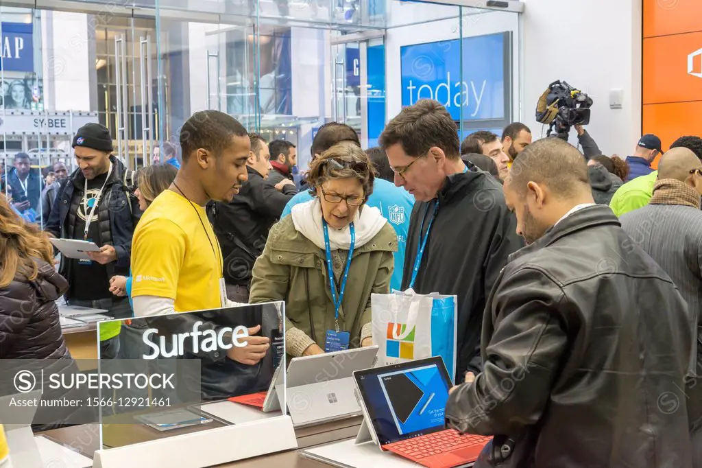 Shoppers try out Surface laptops at the Microsoft flagship store on Fifth Avenue in New York at its grand opening, Monday, October 26, 2015. Visitors ...