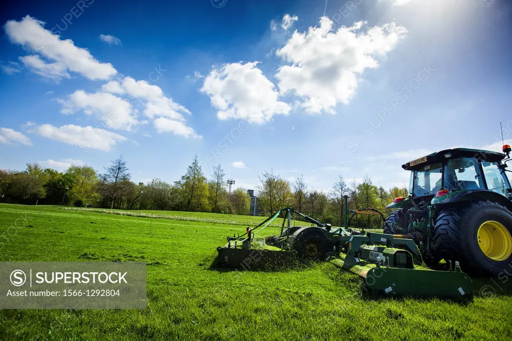 Tractor mowing in king george´s park, southfields, near wimbledon, London, UK