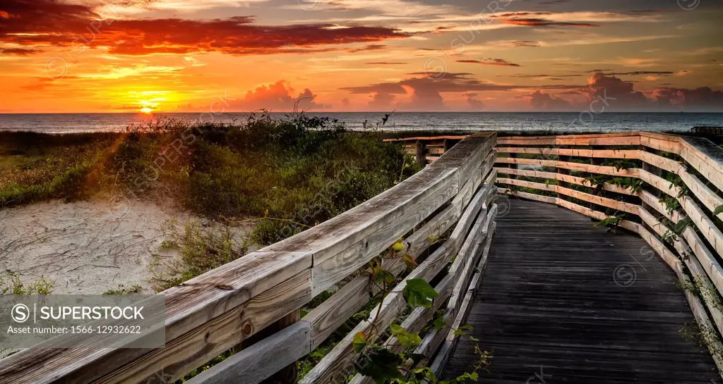 A boardwalk stretches toward the sunrise, Amelia Island, Florida.