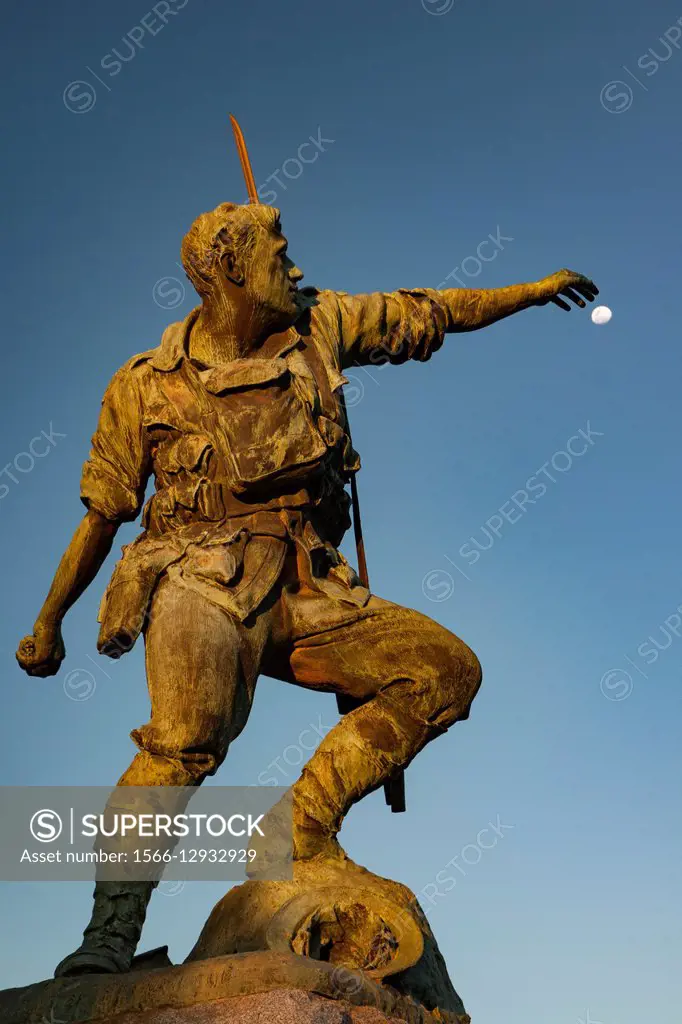 Australian World War I soldier reaches for the moon as he throws hand grenade, memorial statue in main street, Broken Hill western NSW, Australia.