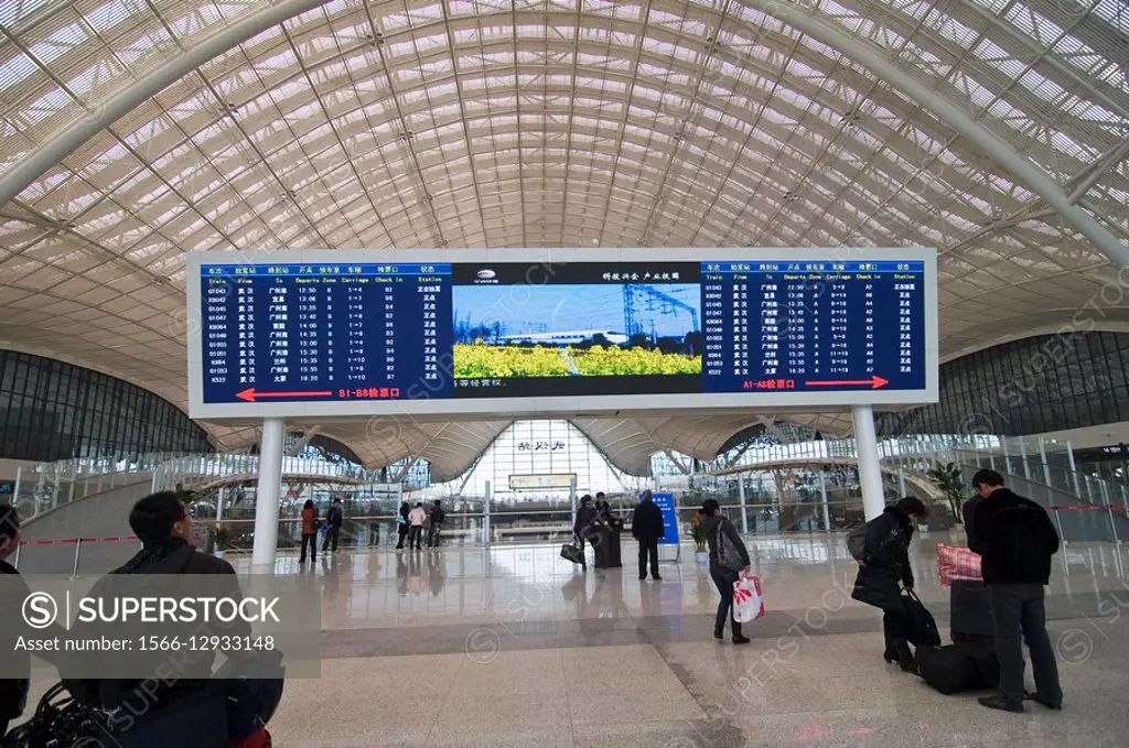 Wuhan´s new railway station. Passengers checking the schedule.