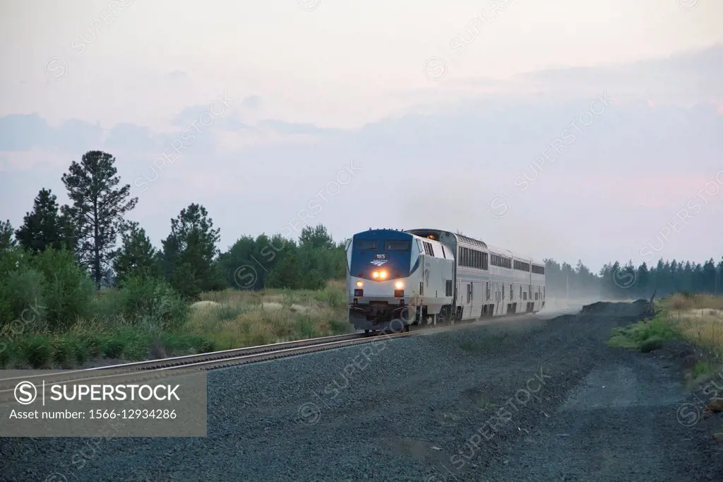 An American Amtrak passenger train travelling near Cheney, Washington, USA in the evening.