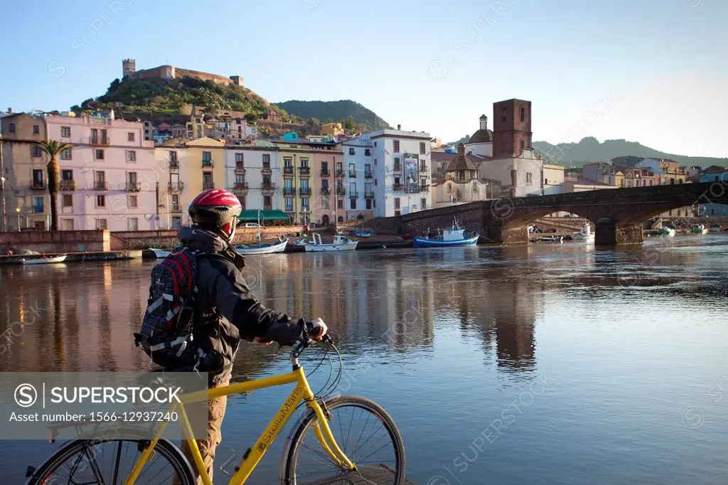 Temo river, cyclist overlooking the Old Bridge, Bosa, Sardinia, Italy