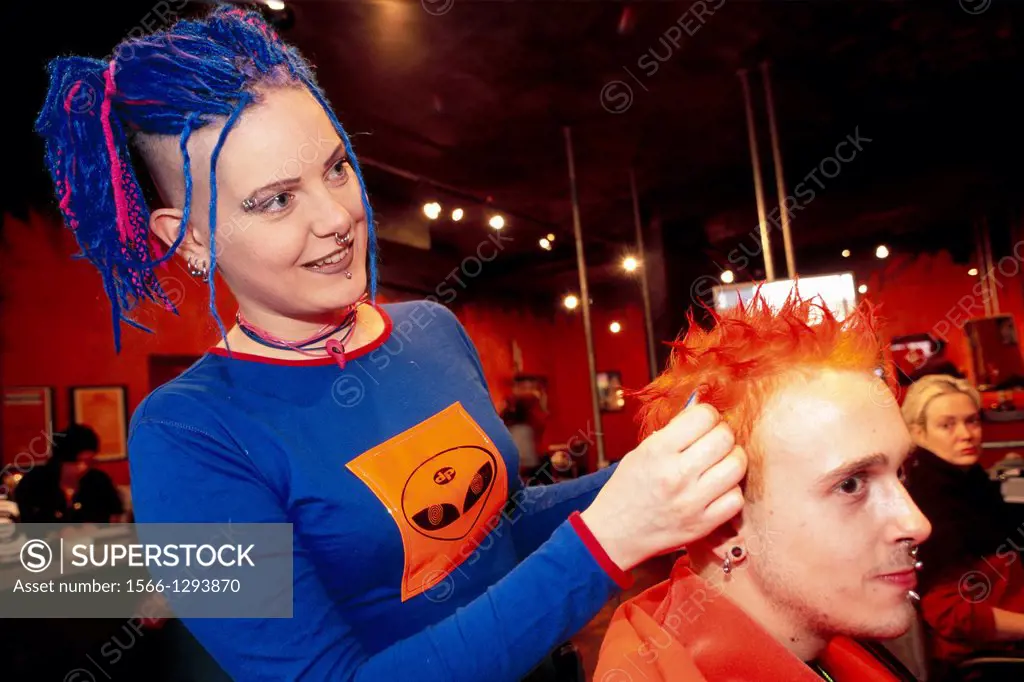 United kingdom london soho rox trendy hairdresser blue haired woman at work on a red haired customer