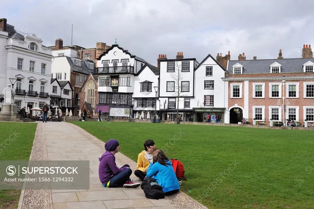 young people sitting on a square near the Cathedral of Exeter, Devon county, England, United Kingdom, Europe.