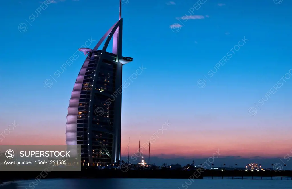 Worlds only 7 star hotel in Dubai UAE called the Burj Al Arab at sunset with luxury and water in United Arab Emirates.