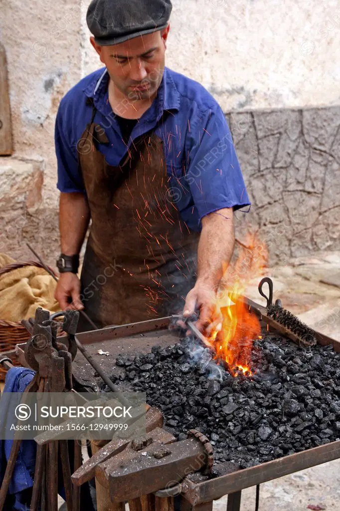 Forge of a blacksmith. Working in street.