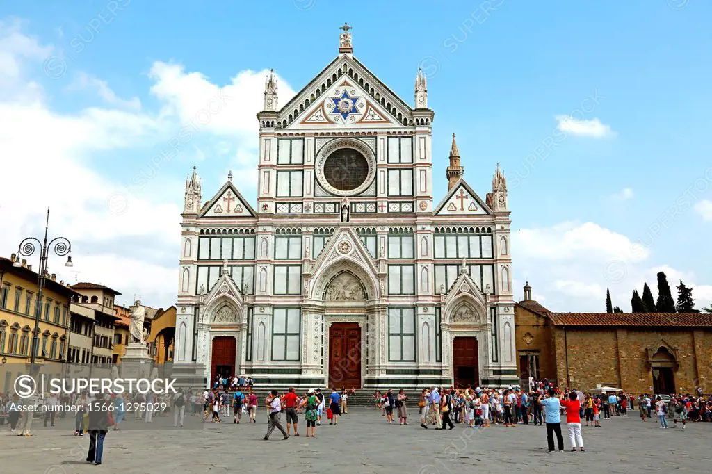 Tourists admiring the front of Basilica Santa Croce in Florence Italy.