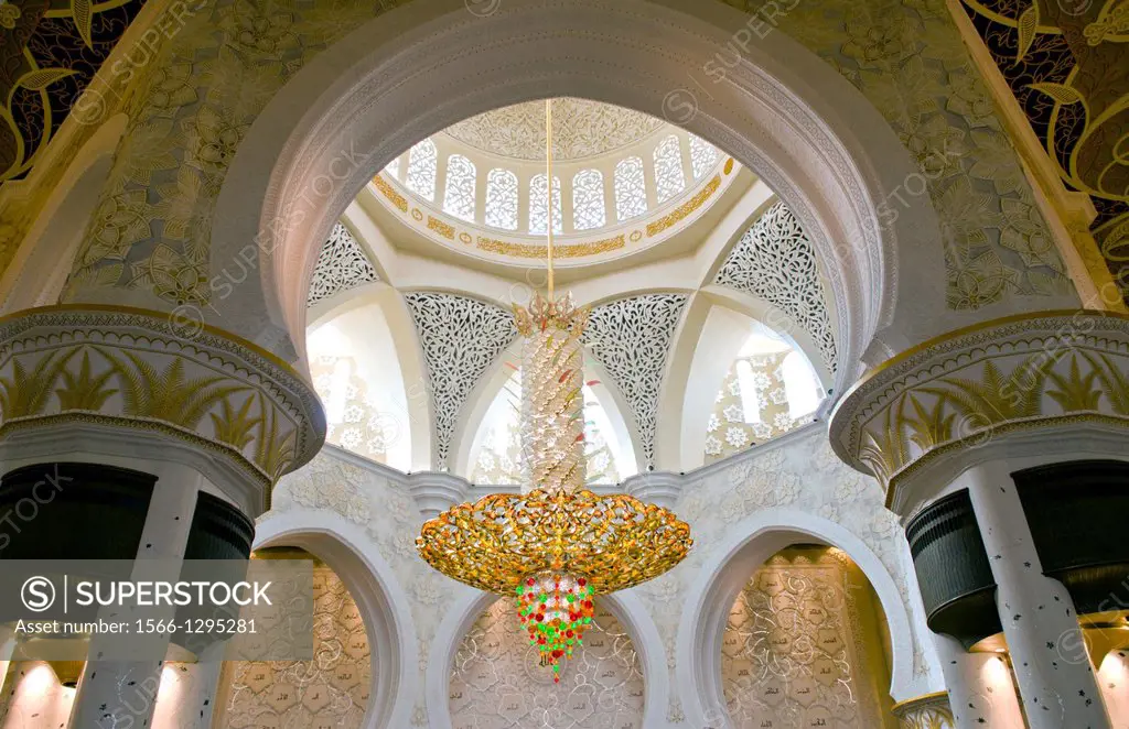 Large colorful chandelier in the beautiful white Sheikh Zayed Grand Mosque in Abu Dhabi in the UAE the worlds 8th largest Muslim mosque in the world.