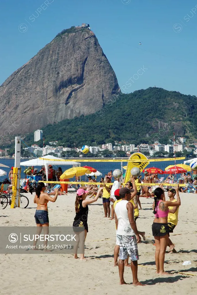 Rio de Janeiro, Brazil, people playing beach-volley at Praia do Flamengo, the Pío de Açúcar on the background